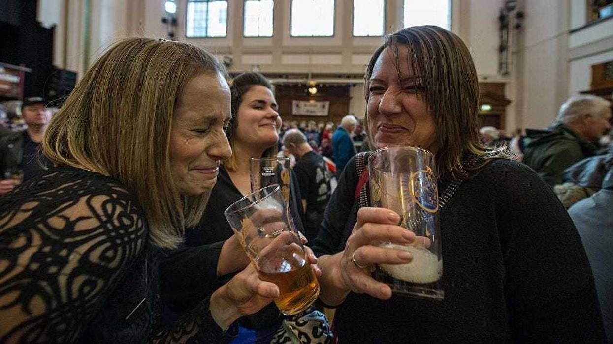 Debroah Cook, 42, Lauren Friend, 27, and her stepmother Dawn Friend, 43, share a laugh over beer and stout at the London Drinker Beer and Cider Festival at the Camden Centre on March 2, 2016 in London, England.
