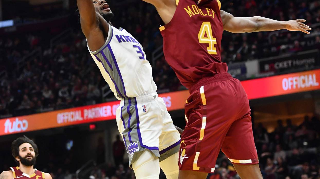Dec 11, 2021; Cleveland, Ohio, USA; Cleveland Cavaliers forward Evan Mobley (4) defends the shot of Sacramento Kings guard Terence Davis (3) during the first half at Rocket Mortgage FieldHouse.