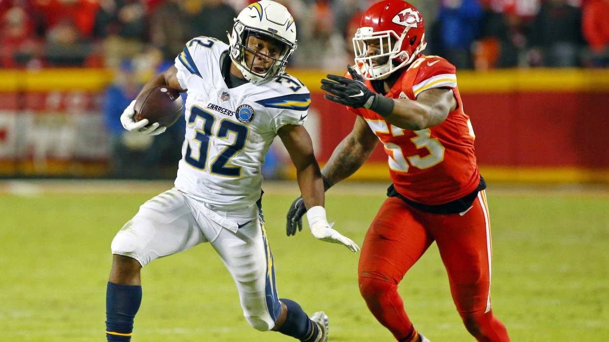 Dec 13, 2018; Kansas City, MO, USA; Los Angeles Chargers running back Justin Jackson (32) runs against Kansas City Chiefs linebacker Anthony Hitchens (53) in the second half at Arrowhead Stadium. Mandatory Credit: Jay Biggerstaff-USA TODAY Sports