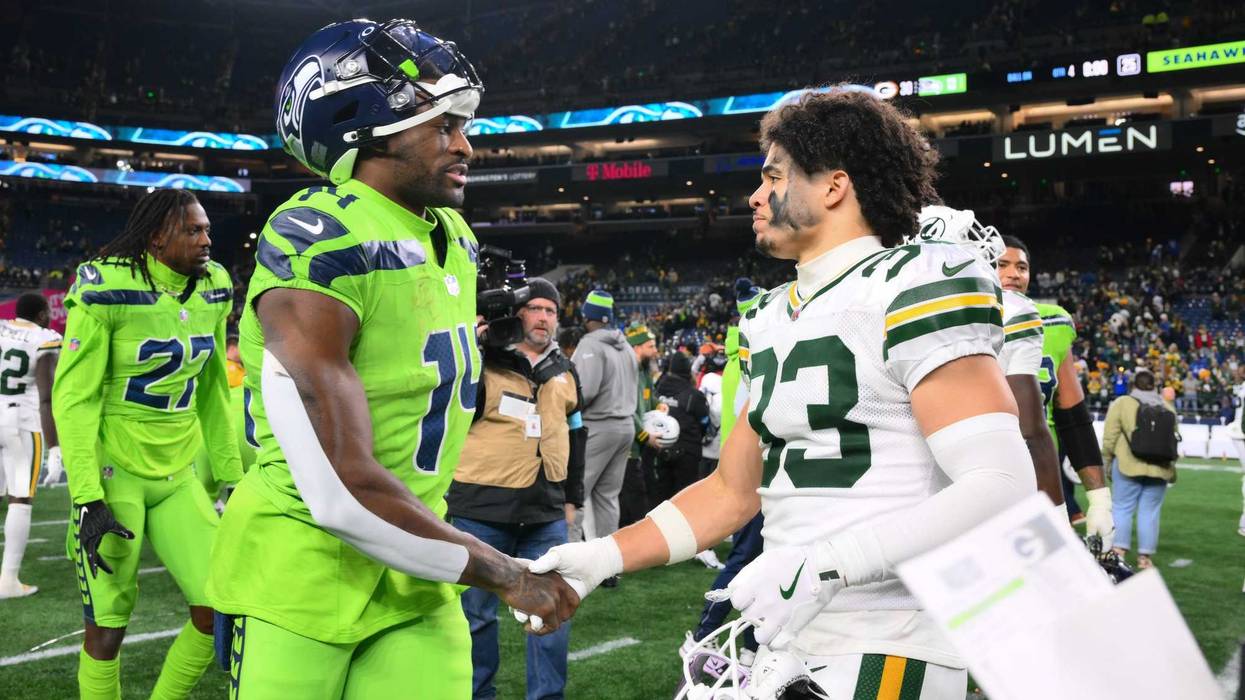 Dec 15, 2024; Seattle, Washington, USA; Seattle Seahawks wide receiver DK Metcalf (14) and Green Bay Packers safety Evan Williams (33) shake hands after the game at Lumen Field. Mandatory Credit: Steven Bisig-Imagn Images
