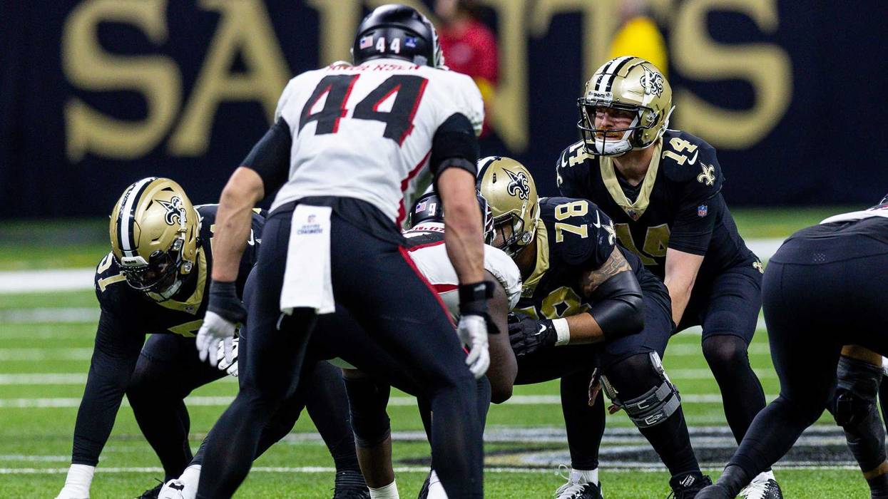 Dec 18, 2022; New Orleans, Louisiana, USA; New Orleans Saints quarterback Andy Dalton (14) goes against Atlanta Falcons linebacker Troy Andersen (44) during the second half at Caesars Superdome. Mandatory Credit: Stephen Lew-USA TODAY Sports