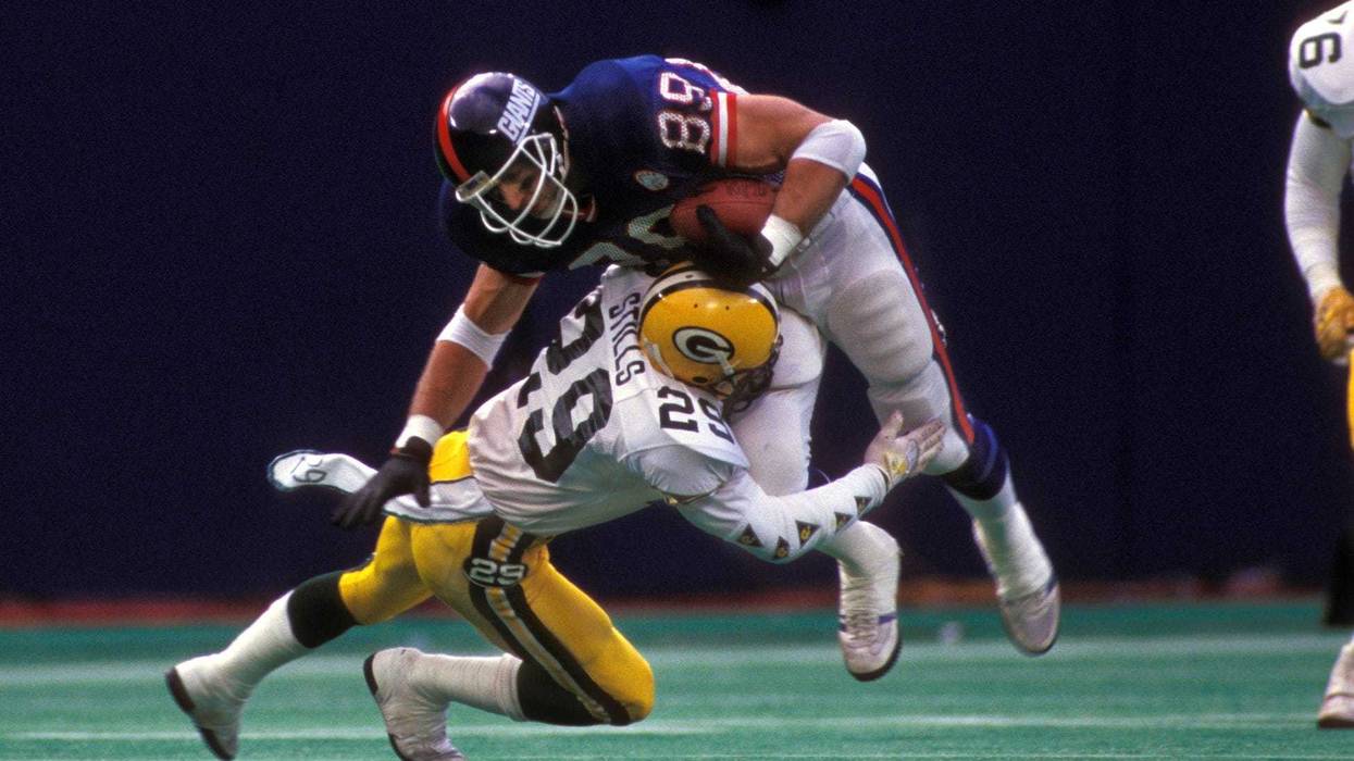 Dec 20, 1986; E. Rutherford, NJ, USA; FILE PHOTO; New York Giants tight end Mark Bavaro (89) is hit by Green Bay Packers defensive back Ken Stills (29) at Giants Stadium. Mandatory Credit: Manny Rubio-USA TODAY Sports