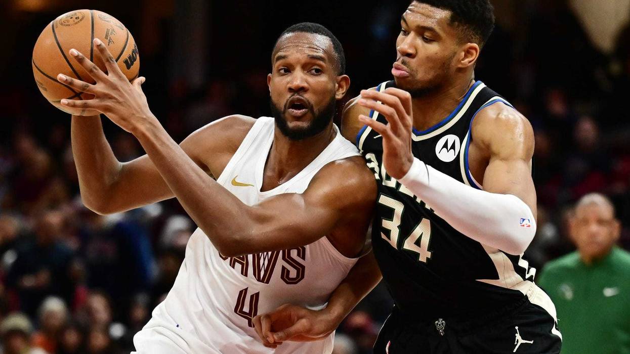 Dec 20, 2024; Cleveland, Ohio, USA; Cleveland Cavaliers forward Evan Mobley (4) drives to the basket against Milwaukee Bucks forward Giannis Antetokounmpo (34) during the second half at Rocket Mortgage FieldHouse