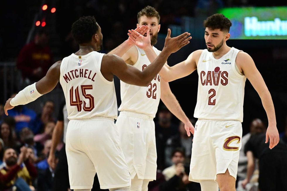 Dec 20, 2024; Cleveland, Ohio, USA; Cleveland Cavaliers guard Ty Jerome (2) celebrates with guard Donovan Mitchell (45) after hitting a three point basket during the first half against the Milwaukee Bucks at Rocket Mortgage FieldHouse.