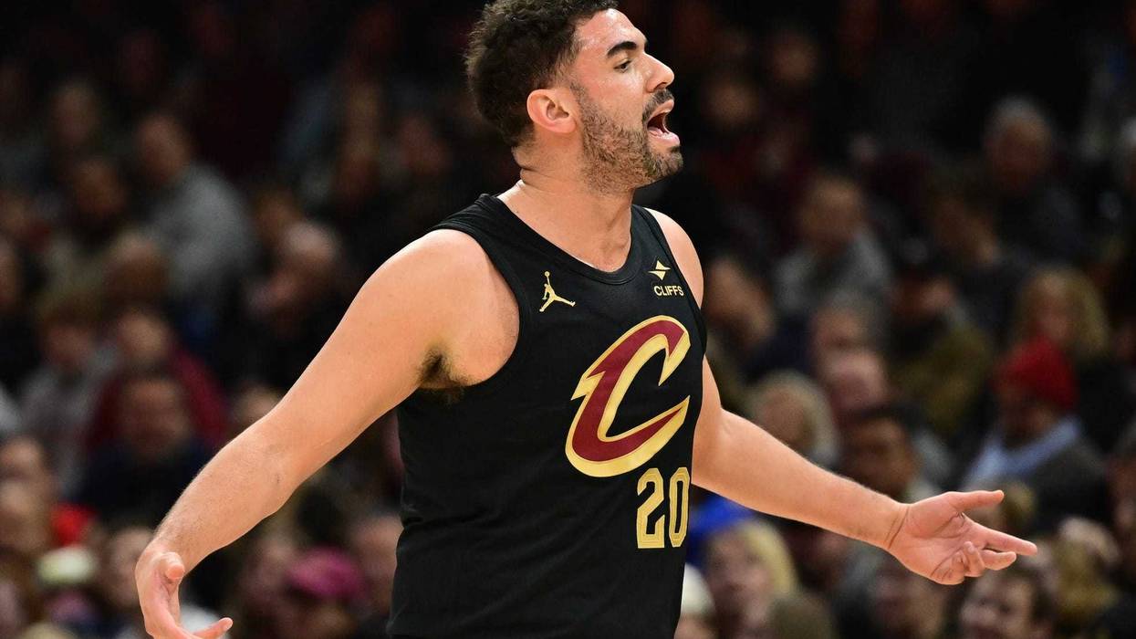 Dec 21, 2024; Cleveland, Ohio, USA; Cleveland Cavaliers forward Georges Niang (20) reacts to the players on the Philadelphia 76ers bench during the first half at Rocket Mortgage FieldHouse.