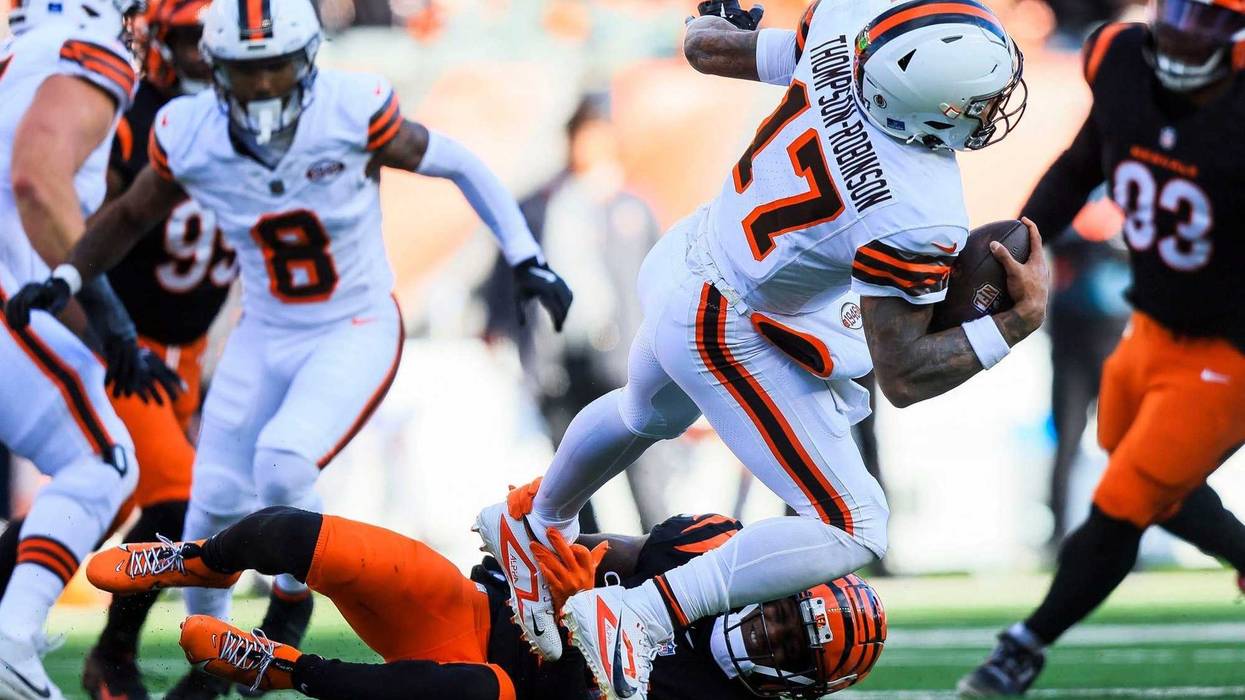 Dec 22, 2024; Cincinnati, Ohio, USA; Cincinnati Bengals cornerback Mike Hilton (21) sacks Cleveland Browns quarterback Dorian Thompson-Robinson (17) in the first half at Paycor Stadium.