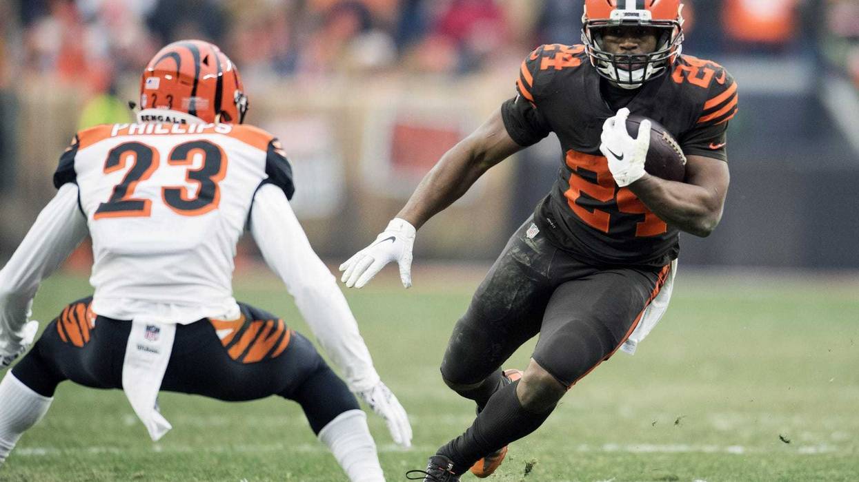 Dec 23, 2018; Cleveland, OH, USA; Cleveland Browns running back Nick Chubb (24) runs with the ball as Cincinnati Bengals cornerback Darius Phillips (23) defends during the second half at FirstEnergy Stadium. Mandatory Credit: Ken Blaze-USA TODAY Sports
