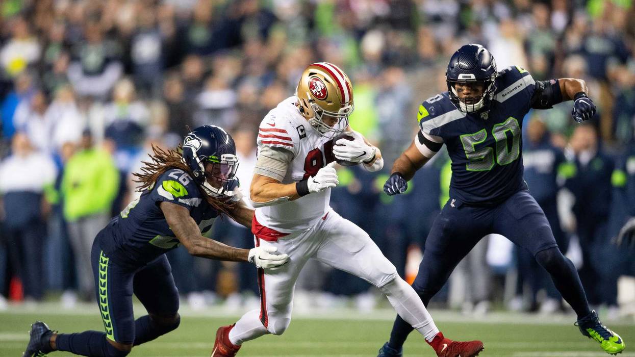 Dec 29, 2019; Seattle, Washington, USA; San Francisco 49ers tight end George Kittle (85) fights off Seattle Seahawks cornerback Shaquill Griffin (26) and Seattle Seahawks outside linebacker K.J. Wright (50) after making a catch during the first half at CenturyLink Field.