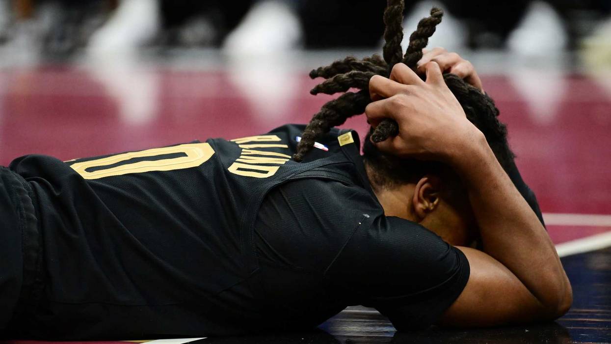 Dec 3, 2024; Cleveland, Ohio, USA; Cleveland Cavaliers guard Darius Garland (10) lies on the court after colliding with Washington Wizards center Jonas Valanciunas (not pictured) during the second half at Rocket Mortgage FieldHouse.