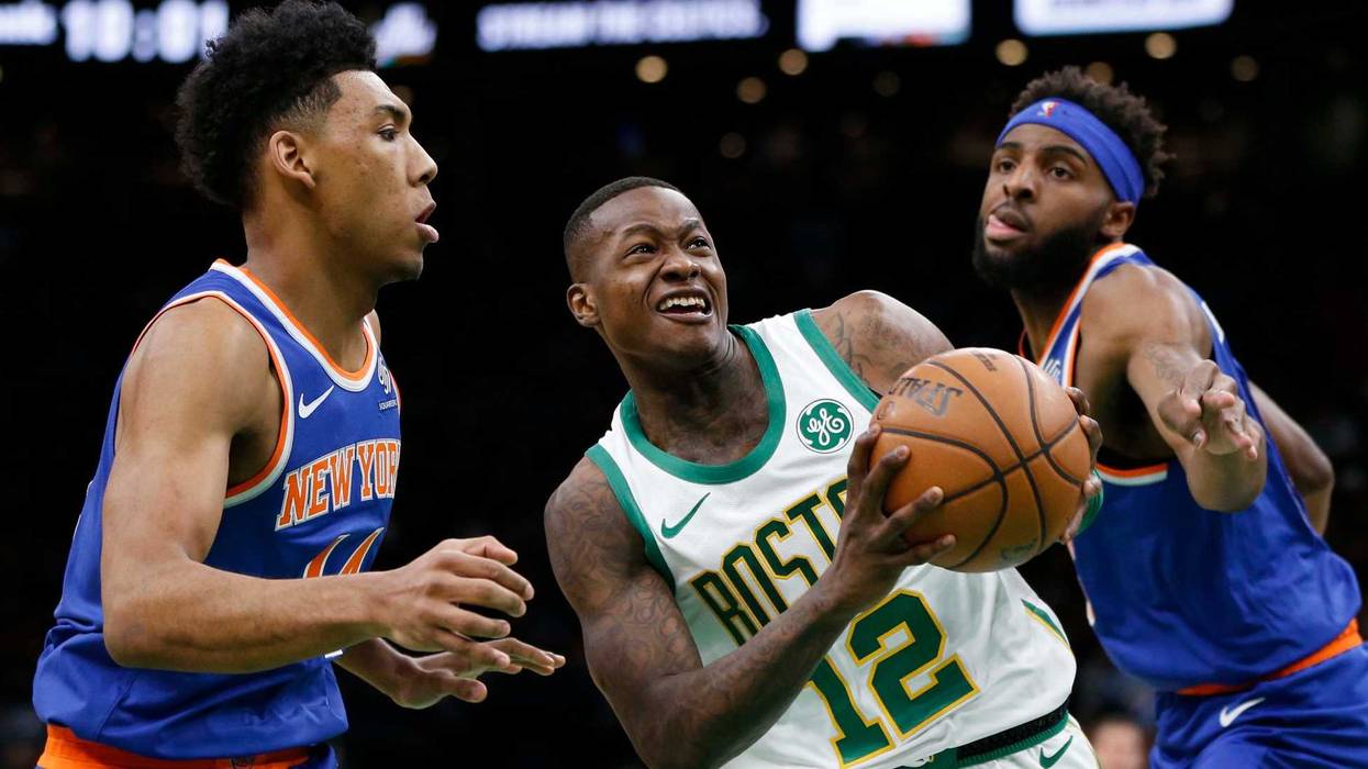 Dec 6, 2018; Boston, MA, USA; Boston Celtics guard Terry Rozier (12) is guarded by New York Knicks guard Allonzo Trier (14) and center Mitchell Robinson (26) during the second half at TD Garden. Mandatory Credit: Greg M. Cooper-USA TODAY Sports