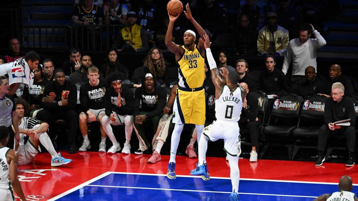 Dec 7, 2023; Las Vegas, Nevada, USA; Indiana Pacers center Myles Turner (33) shoots the basketball as Milwaukee Bucks guard Damian Lillard (0) defends during the second quarter at T-Mobile Arena. Mandatory Credit: Candice Ward-Imagn Images