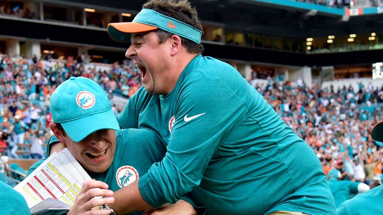 Dec 9, 2018; Miami Gardens, FL, USA; Adam Gase (middle) celebrates with Dolphins offensive coordinator Dowell Loggains (right) after defeating the New England Patriots at Hard Rock Stadium. Mandatory Credit: Steve Mitchell-USA TODAY