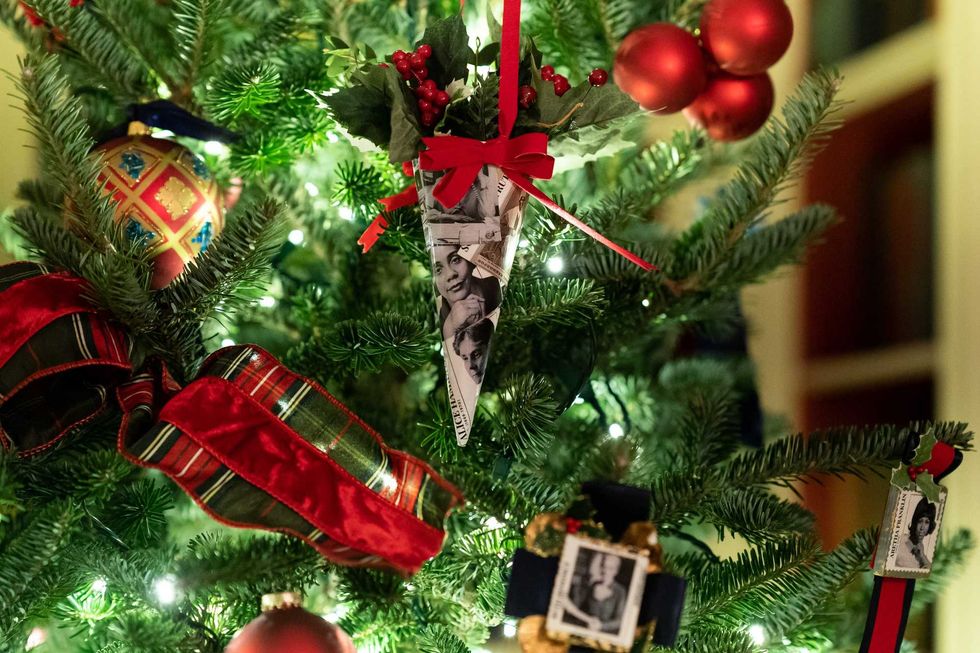 Decorations with photographs of historic American female leaders decorate the trees in the White House Library Sunday, Nov. 29, 2020.