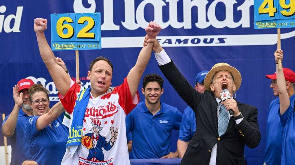 Defending champion Joey Chestnut cheers after finishing in first place in the 2023 Nathan's Famous Fourth of July International Hot Dog Eating Contest on July 4, 2023 at Coney Island in Brooklyn.