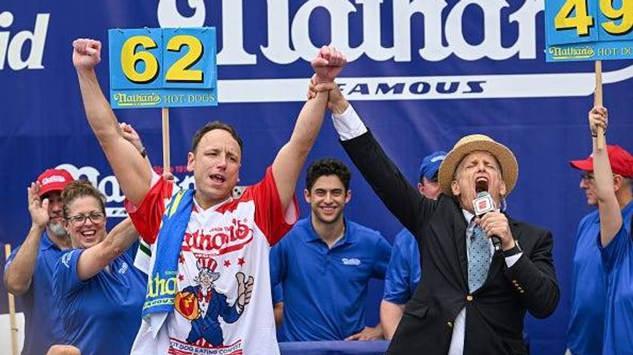 Defending champion Joey Chestnut cheers after finishing in first place in the 2023 Nathan's Famous Fourth of July International Hot Dog Eating Contest on July 4, 2023 at Coney Island in the Brooklyn borough of New York City