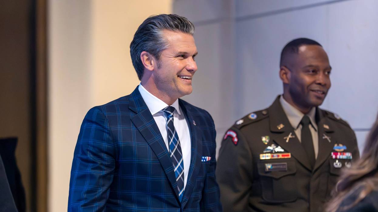 Defense Secretary Pete Hegseth smiles as he walks to a secure room in the basement of the Capitol to brief lawmakers on how he handled a military strike on a suspected drug smuggling boat and its crew in the Caribbean near Venezuela Sept. 2, at the Capitol in Washington, Tuesday, Dec. 9, 2025.