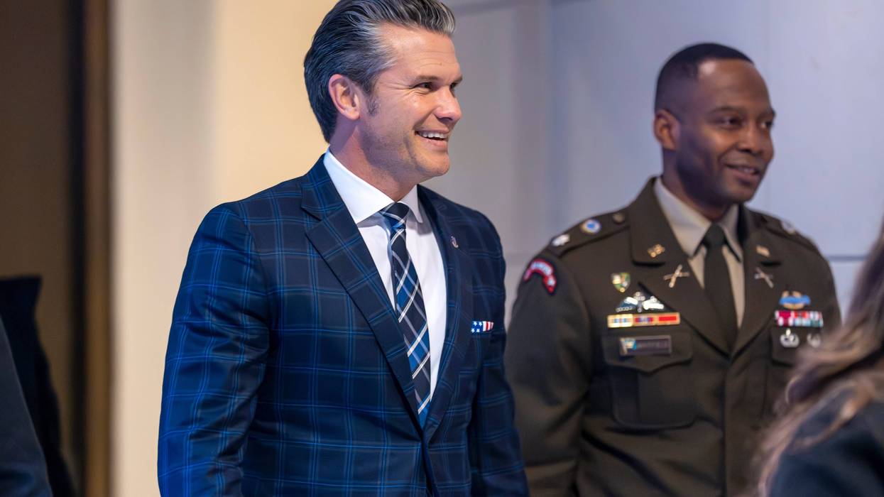 Defense Secretary Pete Hegseth smiles as he walks to a secure room in the basement of the Capitol to brief lawmakers on how he handled a military strike on a suspected drug smuggling boat and its crew in the Caribbean near Venezuela Sept. 2, at the Capitol in Washington, Tuesday, Dec. 9, 2025.