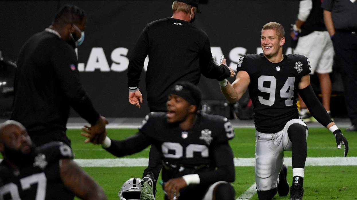 Defensive end Carl Nassib #94 of the Las Vegas Raiders is greeted by head coach Jon Gruden during warmups before a game against the Kansas City Chiefs at Allegiant Stadium on November 22, 2020 in Las Vegas, Nevada.