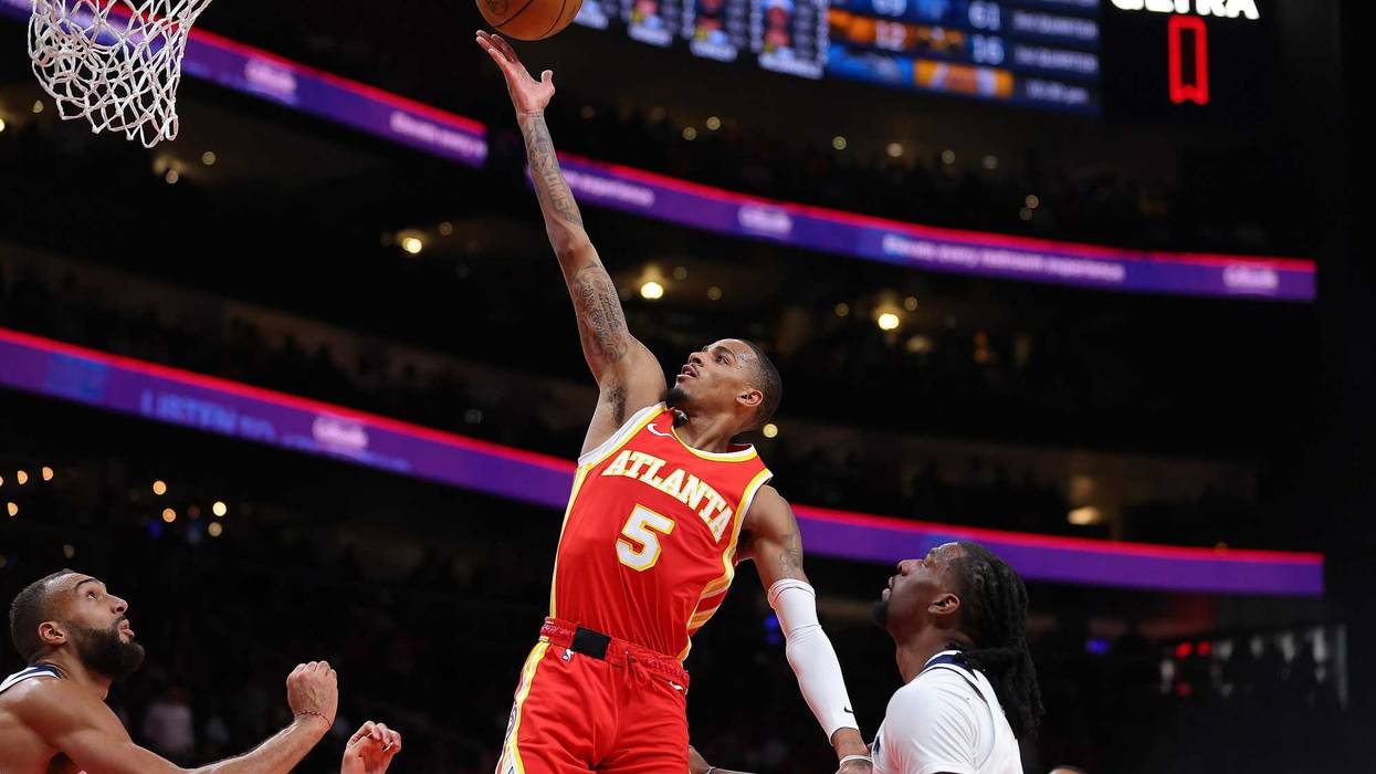 Dejounte Murray #5 of the Atlanta Hawks drives against Rudy Gobert #27 and Naz Reid #11 of the Minnesota Timberwolves during the fourth quarter at State Farm Arena