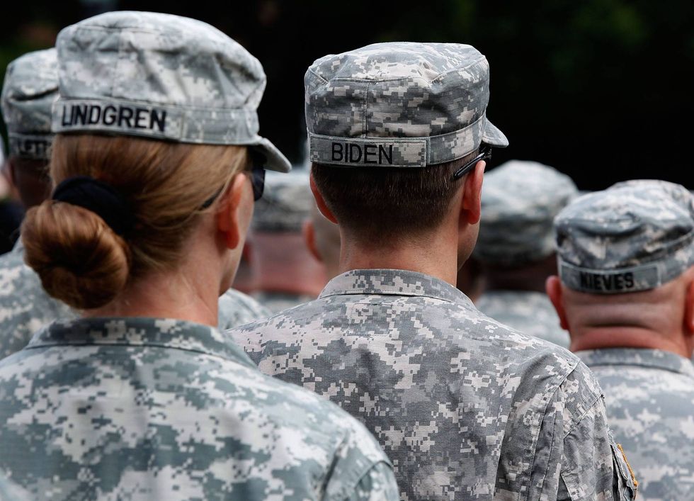 Delaware Attorney General Capt. Joseph "Beau" Biden III (C) stands with other members of the Delaware Army National Guard 261st Signal Brigade during a welcome home ceremony honoring the Delaware Army National Guard 261st Signal Brigade at Legislative Mall on September 30, 2009 in Dover, Delaware. Vice President Joe Biden