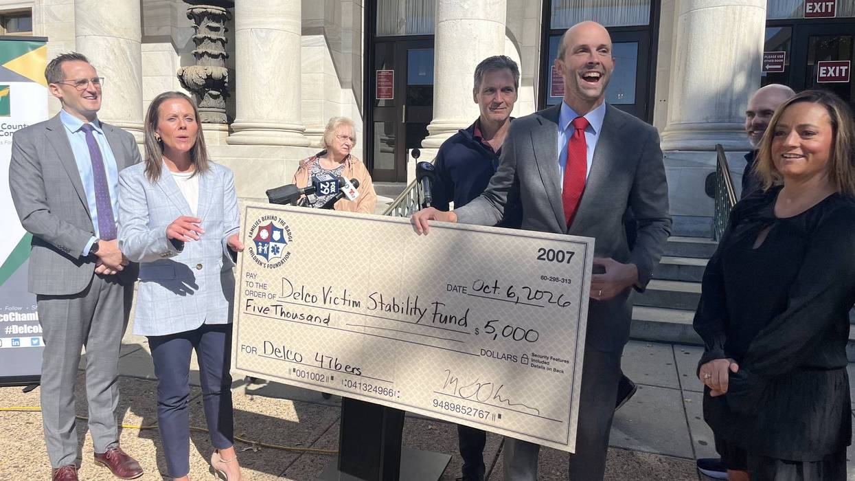 Delaware County District Attorney Tanner Rouse holds a check from Families Behind the Badge Children's Foundation for the Delco Victim Stability Fund.