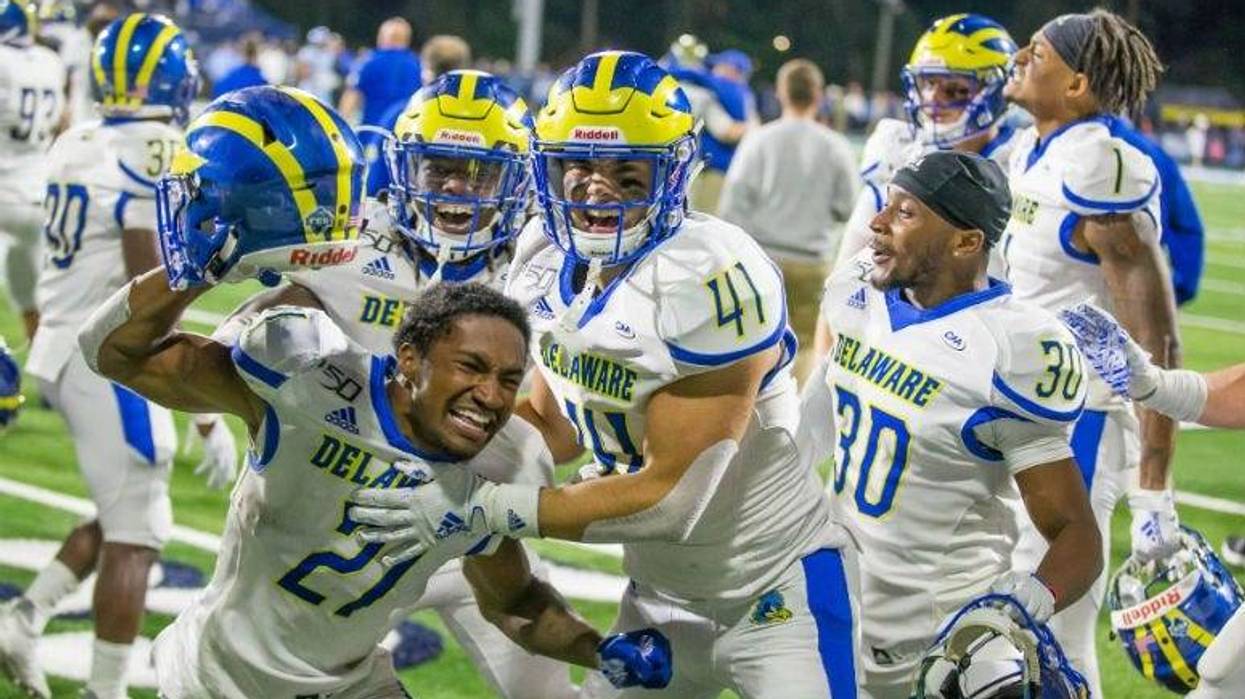 Delaware football players celebrates last week's triple-overtime win at Rhode Island.