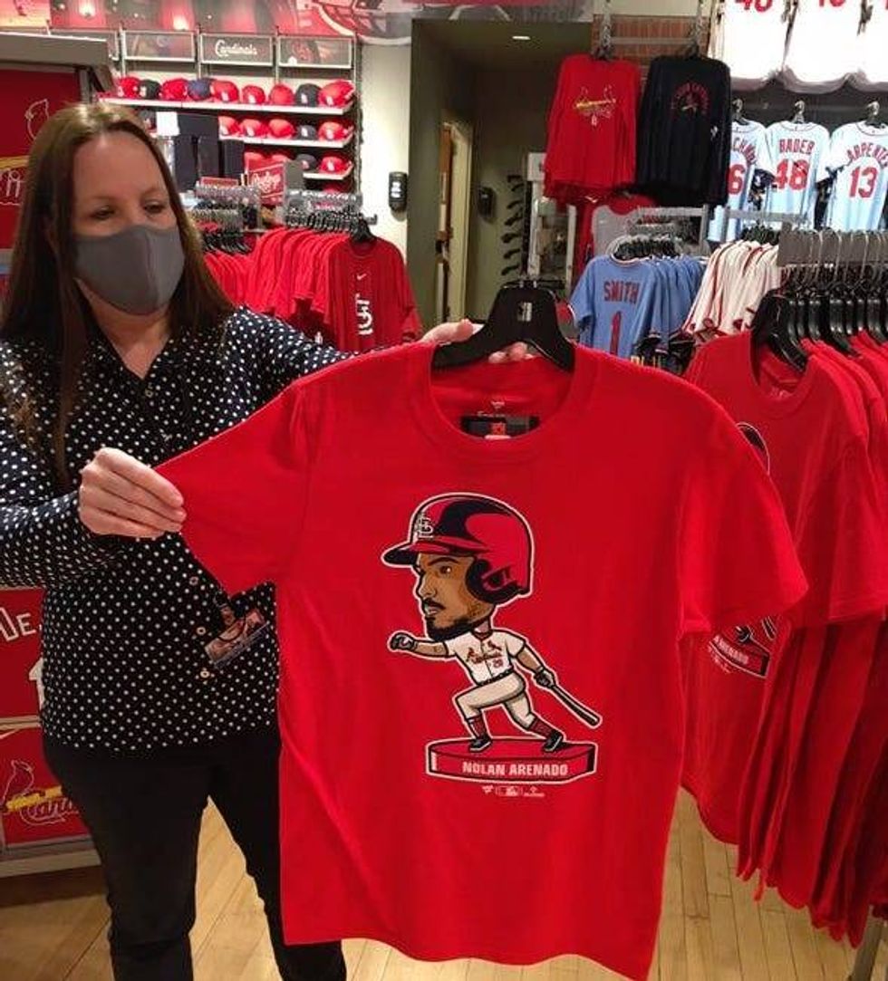 Delaware North Retail Director Stephanie Spargur displays a Nolan Arenado bobblehead t-shirt