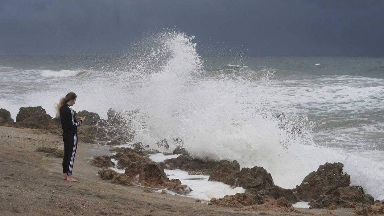 Delia Raresheid, of Stuart, takes photographs of the waves as Martin County remains under a tropical storm warning as Hurricane Ian nears the west coast on Wednesday, Sept. 28, 2022, at Ross Witham Beach on Hutchinson Island.