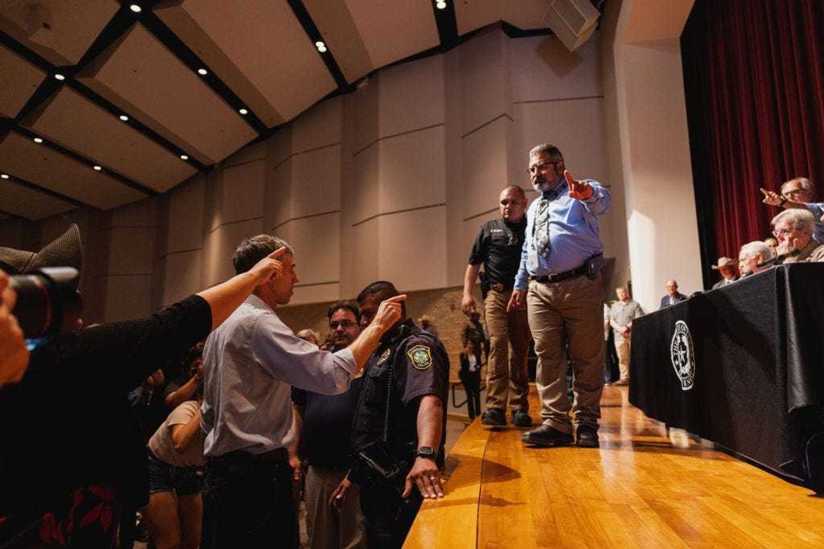 Democratic gubernatorial candidate Beto O'Rourke (L) interrupts a press conference held by Texas Gov. Greg Abbott following a shooting yesterday at Robb Elementary School which left 21 dead including 19 children, on May 25, 2022 in Uvalde, Texas. The shooter, identified as 18 year old Salvador Ramos, was reportedly killed by law enforcement. (Photo by Jordan Vonderhaar/Getty Images)