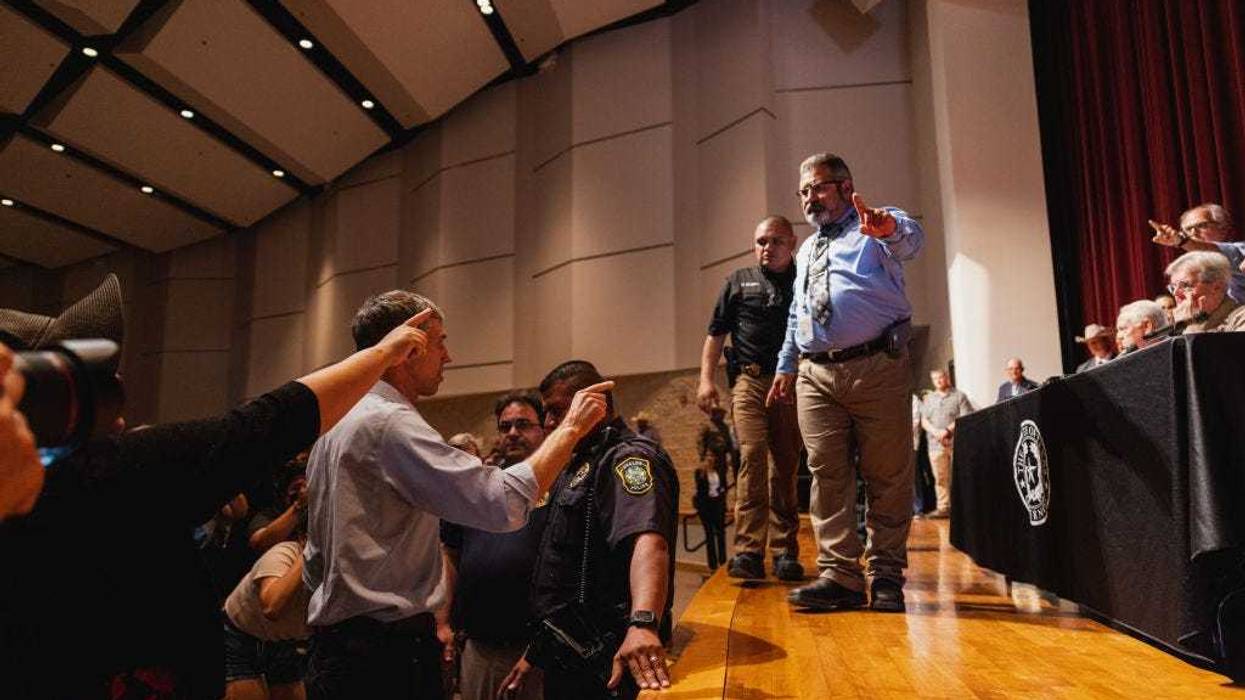 Democratic gubernatorial candidate Beto O'Rourke (L) interrupts a press conference held by Texas Gov. Greg Abbott following a shooting yesterday at Robb Elementary School which left 21 dead including 19 children, on May 25, 2022 in Uvalde, Texas. The shooter, identified as 18 year old Salvador Ramos, was reportedly killed by law enforcement. (Photo by Jordan Vonderhaar/Getty Images)