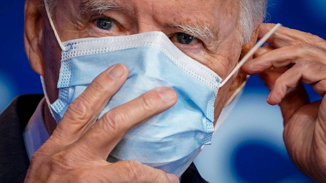 Democratic presidential nominee Joe Biden puts on his face mask after making remarks about the Affordable Care Act and COVID-19 after attending a virtual coronavirus briefing with medical experts at The Queen theater on October 28, 2020 in Wilmington, Delaware.