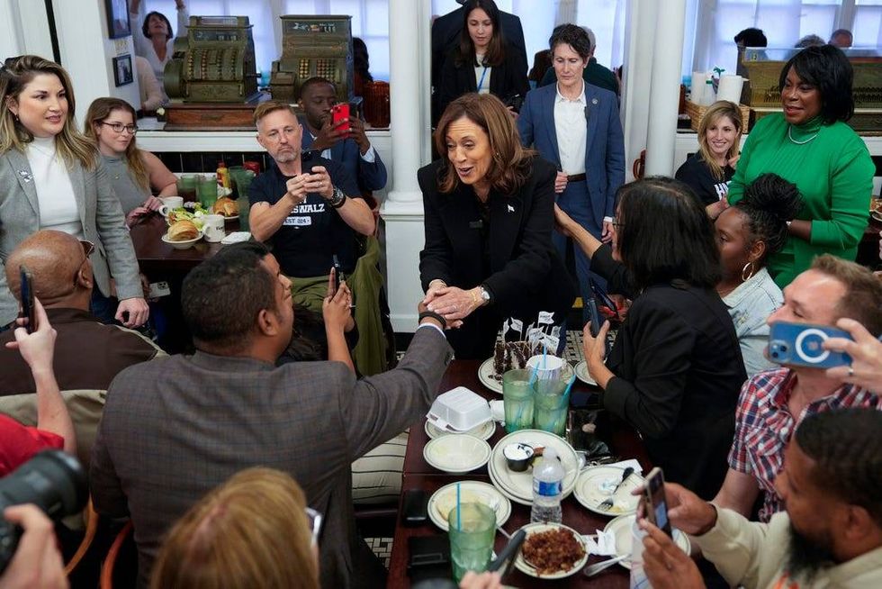 Democratic presidential nominee Vice President Kamala Harris, with Philadelphia Mayor Cherelle Parker, right, speaks to workers and patrons at a campaign stop at Famous 4th Street Delicatessen in Philadelphia on Wednesday.