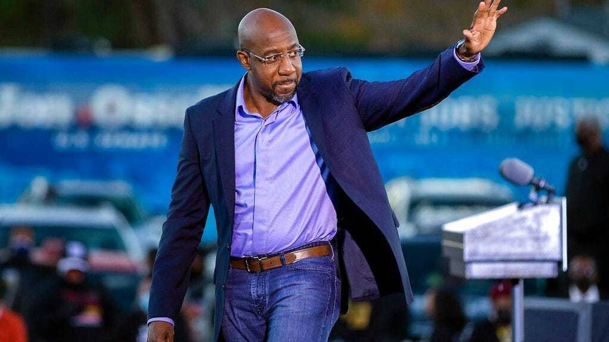 Democratic U.S. Senate candidate Rev. Raphael Warnock waves to supporters during a drive-in rally, Sunday, Jan. 3, 2021, in Savannah, Ga. (AP Photo/Stephen B. Morton)