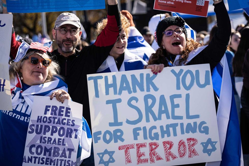 Demonstrators cheer as they attend the March for Israel on the National Mall November 14, 2023 in Washington, DC.