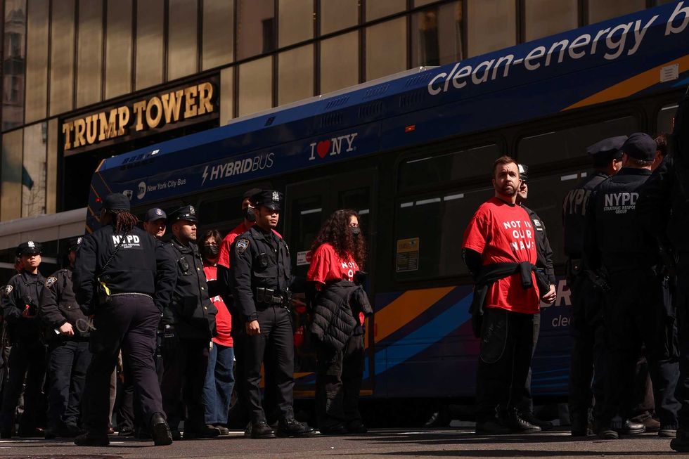 Demonstrators from the group, Jewish Voice for Peace, who were arrested while protesting inside Trump Tower, wait to board a bus escorted by NYPD officers, Thursday, March 13, 2025, in New York