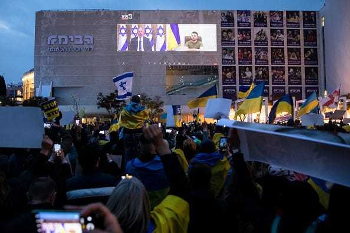 Demonstrators gather to watch Ukrainian President Volodymyr Zelensky's speech to the Israeli parliament as it broadcasted at Habima Square on March 20, 2022 in Tel Aviv, Israel.