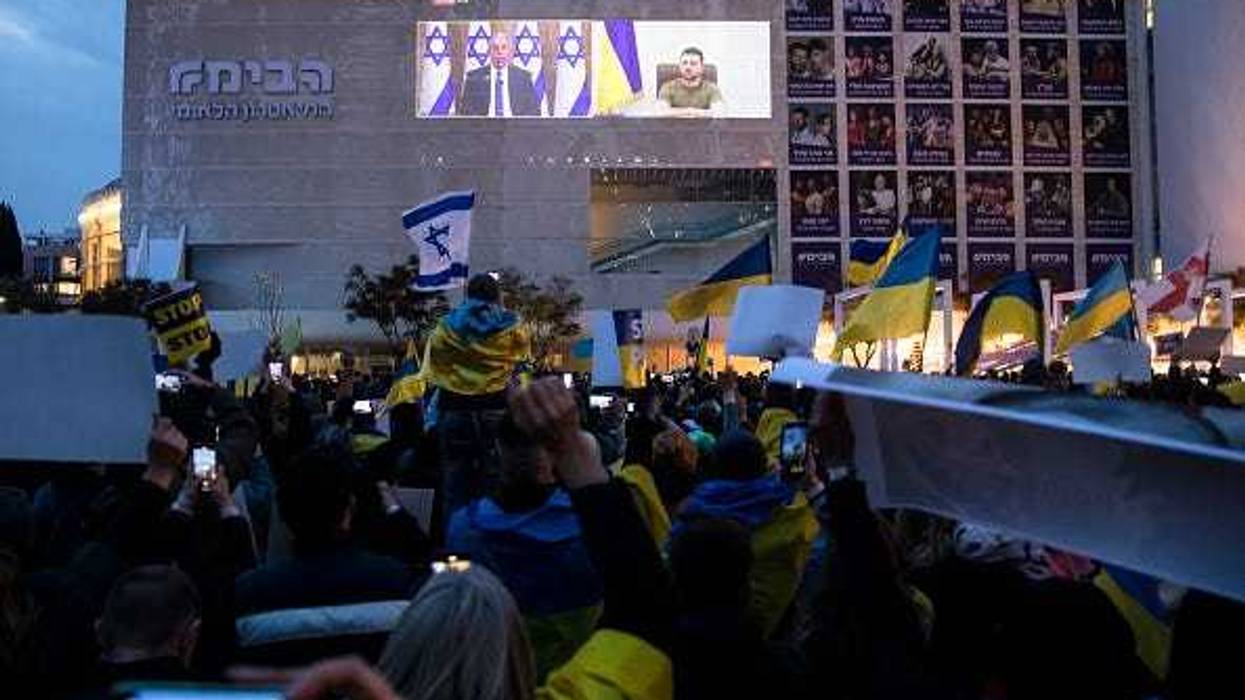 Demonstrators gather to watch Ukrainian President Volodymyr Zelensky's speech to the Israeli parliament as it broadcasted at Habima Square on March 20, 2022 in Tel Aviv, Israel.
