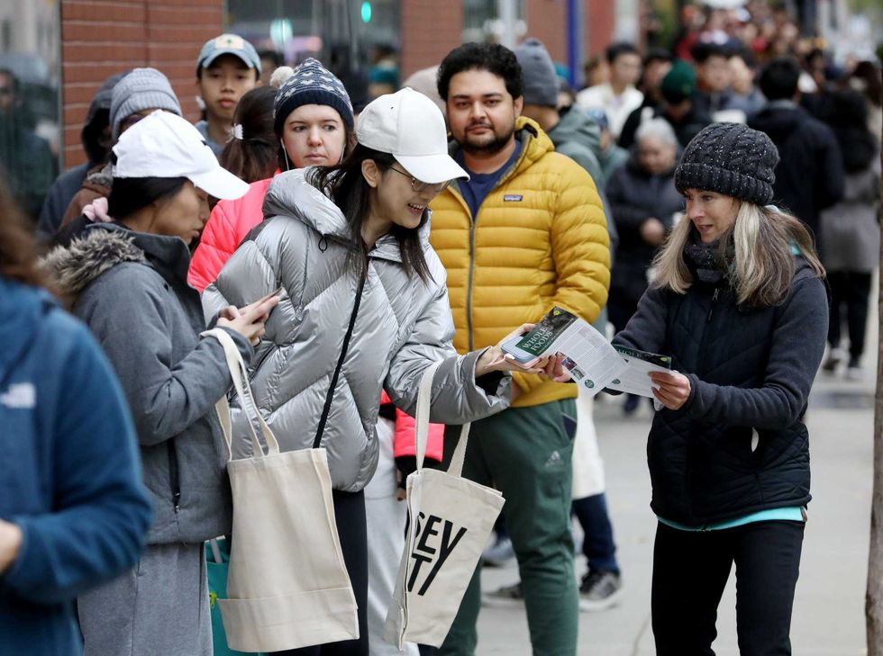 Demonstrators handing out leaflets in front of the new Jersey City Whole Foods Market on Thursday.