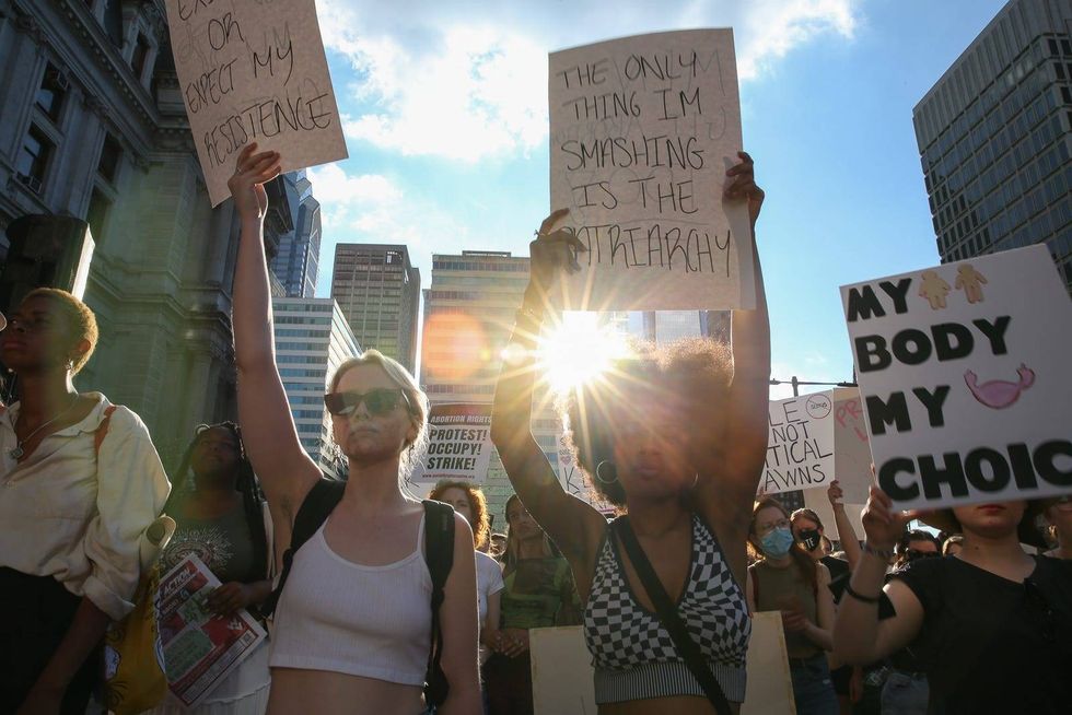 Demonstrators protest agains t SCOTRUS decision to undo Roe v. Wade