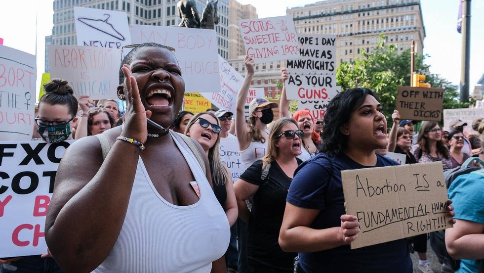 Demonstrators protest agains t SCOTRUS decision to undo Roe v. Wade