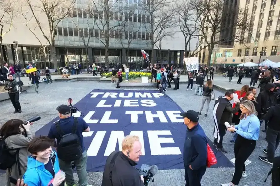 Demonstrators protest against former President Donald Trump at Collect Pond Park near the courthouse ahead of his arraignment hearing on April 04, 2023, in New York City.