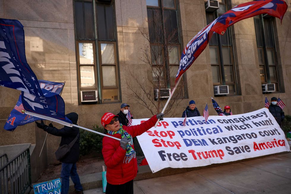 Demonstrators protest outside Manhattan criminal court before the start of the sentencing in President-elect Donald Trump