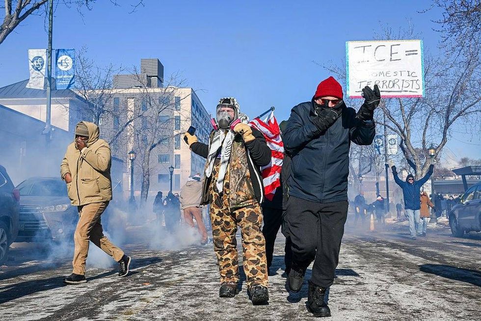 Demonstrators retreat during a protest following a shooting on January 24, 2026 in Minneapolis, Minnesota.