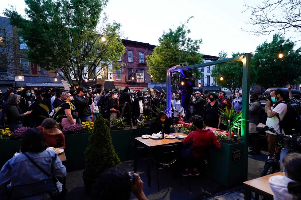 Demonstrators surround outdoor dining in downtown Brooklyn, chanting against gentrification in the neighborhood. Hundreds march through Brooklyn, NY after former police officer Derek Chauvin is convicted in all three counts for the murder of George Floyd on Tuesday, April 20, 2021