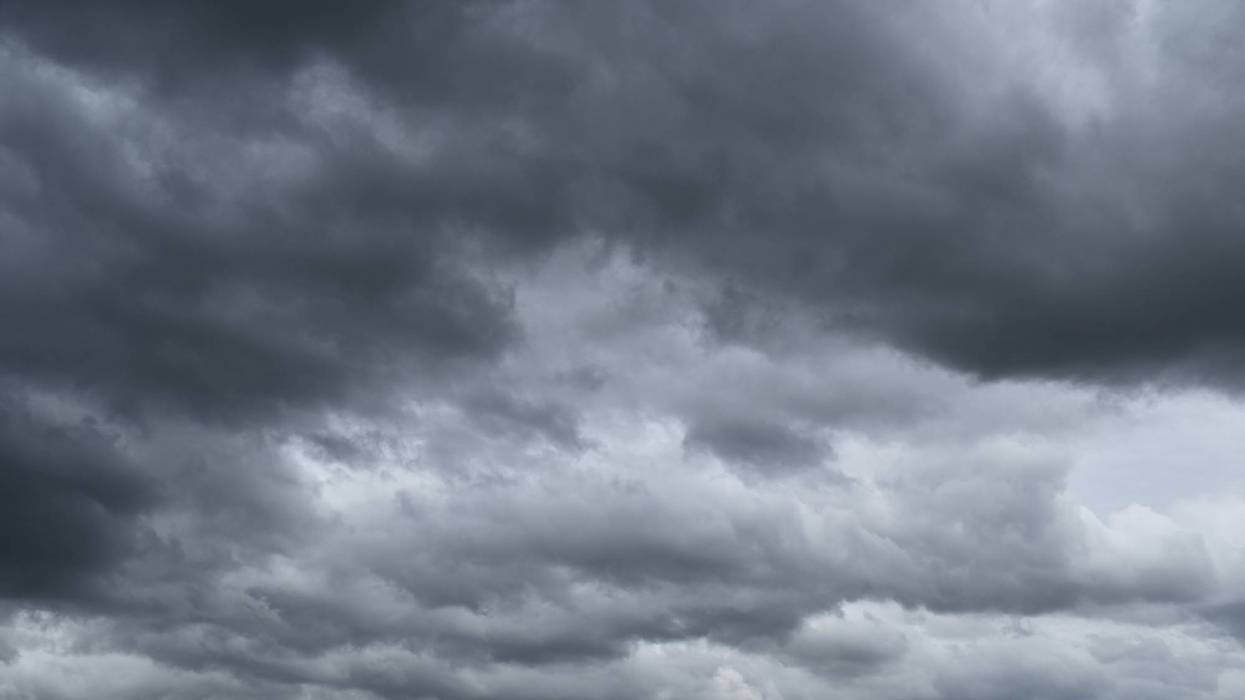 Dense, dark grey storm clouds completely cover the sky.