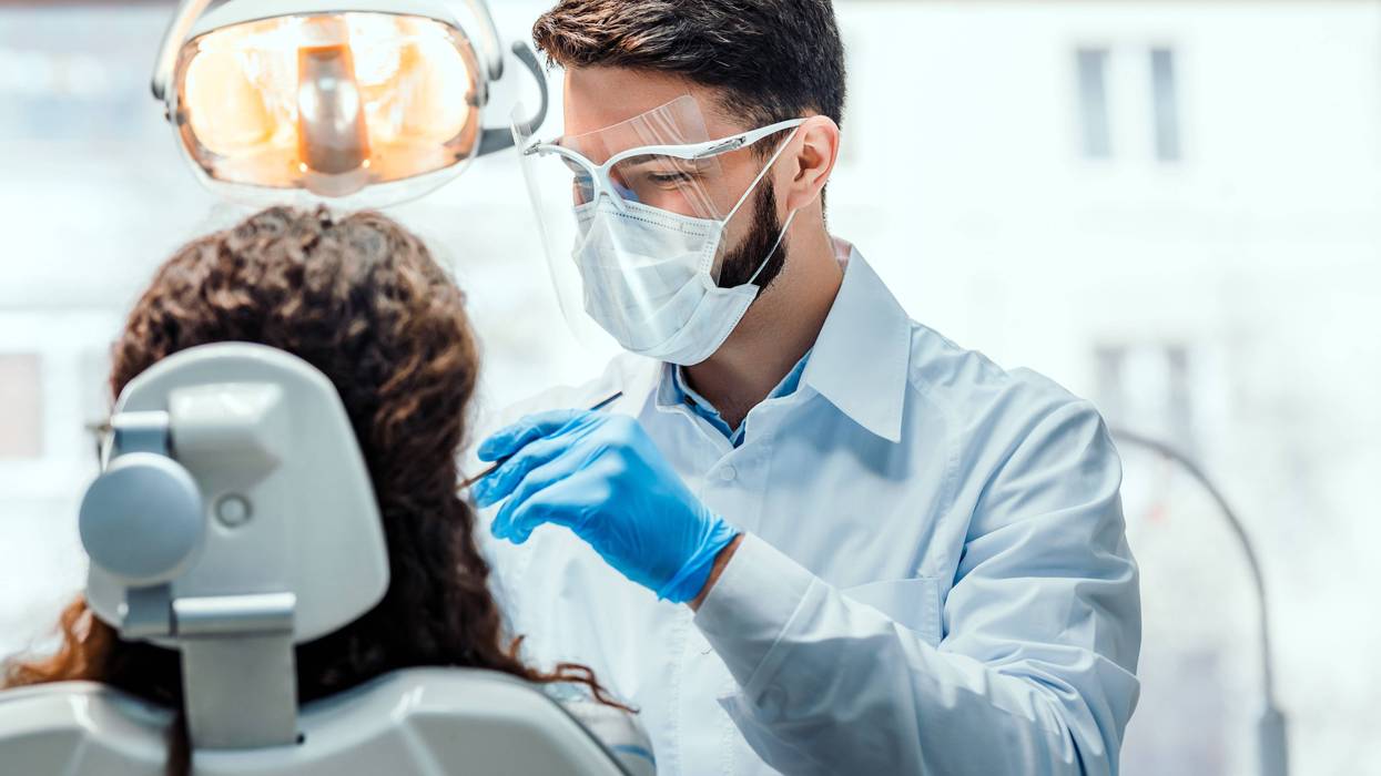 Dentist treats patient