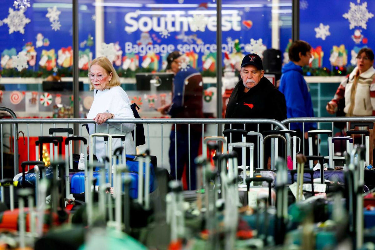 DENVER, CO - DECEMBER 28: Travelers search for their suitcases in a baggage holding area for Southwest Airlines at Denver International Airport on December 28, 2022 in Denver, Colorado. More than 15,000 flights have been canceled by airlines since winter weather began impacting air travel on December 22. (Photo by Michael Ciaglo/Getty Images)