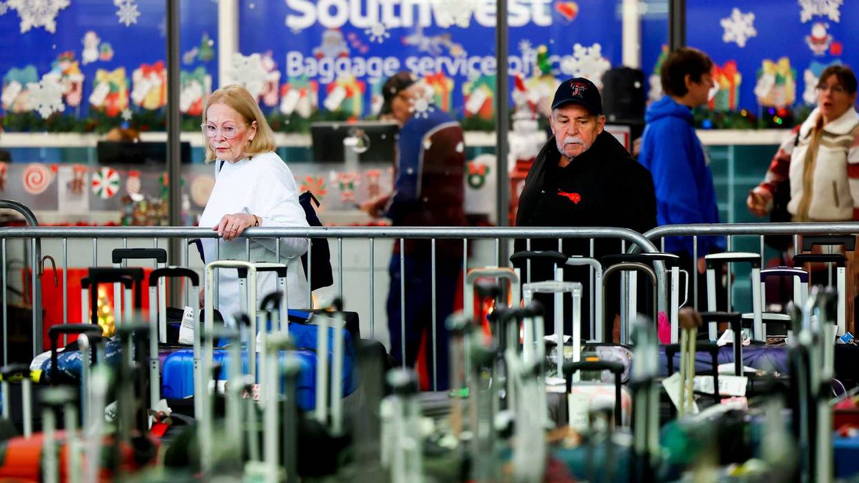 DENVER, CO - DECEMBER 28: Travelers search for their suitcases in a baggage holding area for Southwest Airlines at Denver International Airport on December 28, 2022 in Denver, Colorado. More than 15,000 flights have been canceled by airlines since winter weather began impacting air travel on December 22. (Photo by Michael Ciaglo/Getty Images)