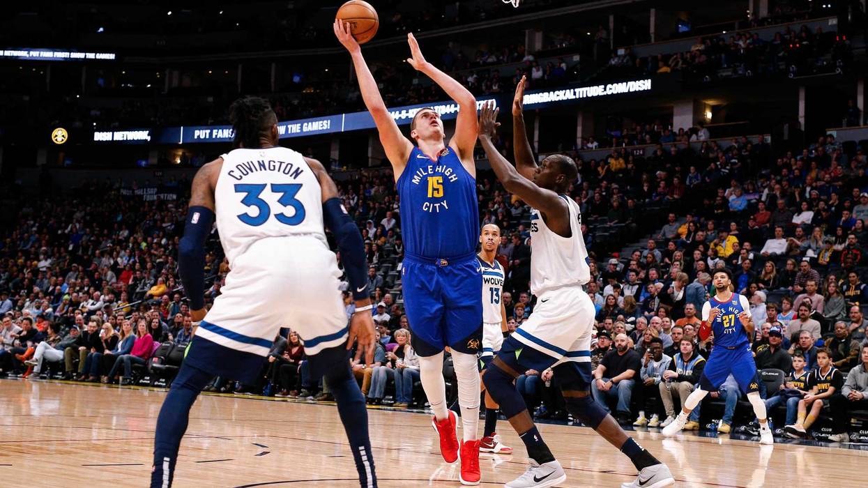Denver Nuggets center Nikola Jokic (15) shoots the ball as Minnesota Timberwolves center Gorgui Dieng (5) defends in the first quarter at the Pepsi Center.