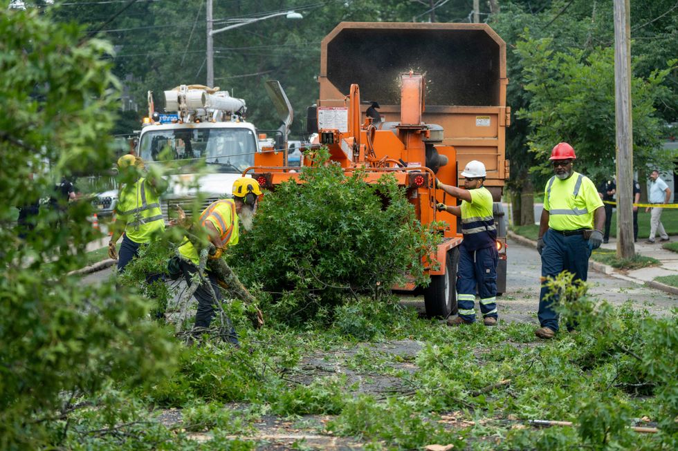 Department of Public Works members clean branches and leaves after a tree fell on Sussex Road in Teaneck on Thursday, Aug. 14, 2025